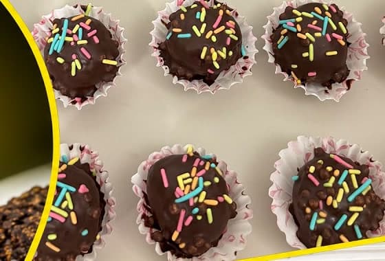 Handmade chocolate truffle balls decorated with colourful sprinkles in mini cups
